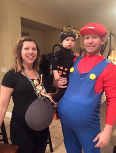 Picture of mom in Wrecking Ball costume, baby in a scuba diver costume and dad as Mario for Halloween