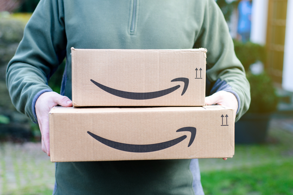 Amazon packages man holding delivery for spring sale