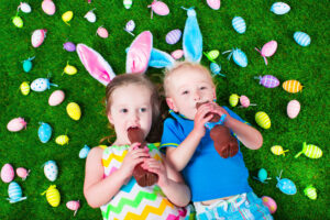 Kids eat chocolate rabbit.