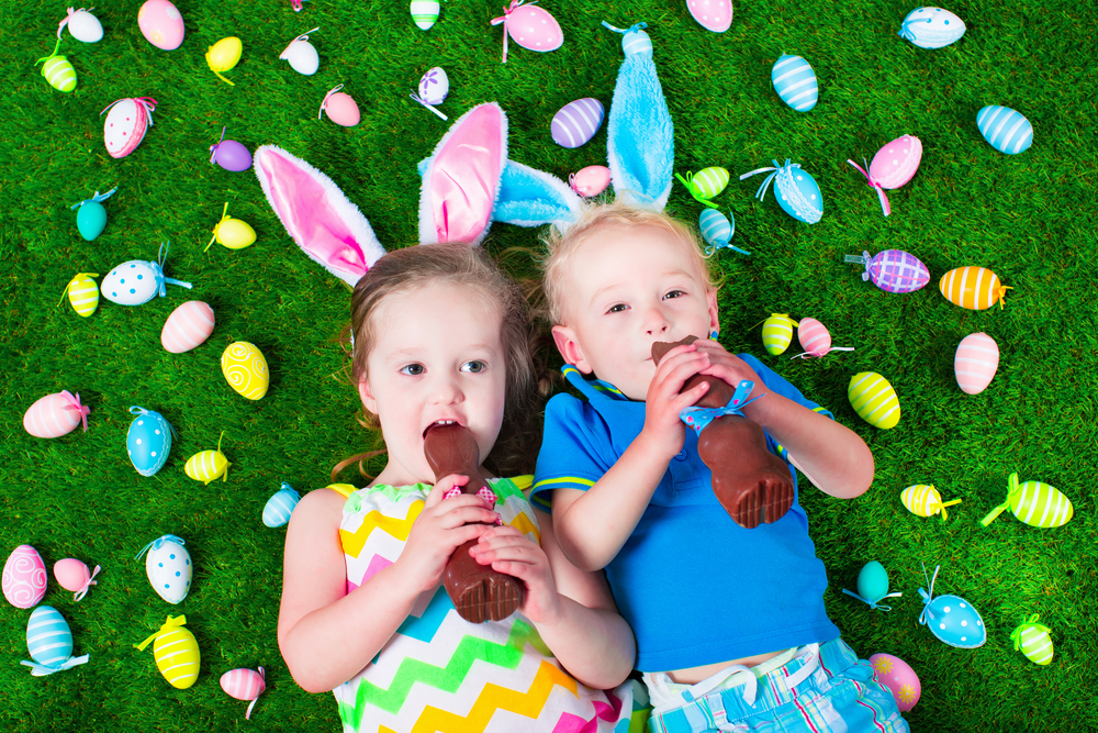 Kids eat chocolate rabbit.